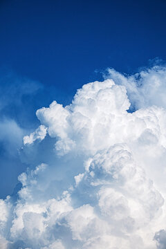 Blue sky background with tiny clouds. © Maksim Shebeko
