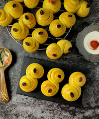 Lussekatter, Swedish S-shaped saffron buns for St Lucia, with a dark background.