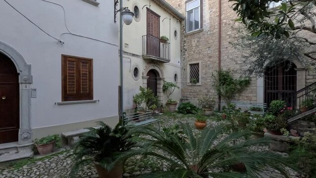A narrow street between the old houses of Gesualdo, a medieval village in Campania, Italy.