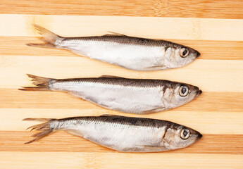 Fresh fish on a wooden background, top view