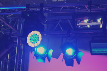 Stage lights on a blue background. The stage is illuminated by the spotlight.