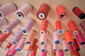 Colorful spools of thread on the table in the tailor shop