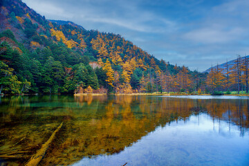 Fototapeta na wymiar Idyllic landscape of Myojin pond at Hotaka Rear shrine in Kamikochi, Nagano, Japan (Japanese language meaning 