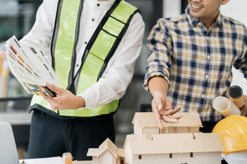 Engineer teams meeting working together wear worker helmets hardhat on construction site. Asian industry professional team.