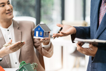 House model with agent asking costumer for contract to buy, get insurance or loan real estate or property.
