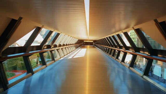 Point of view shot of a large hexagonal concourse, exposed to the exterior revealing the business district a large metropolis