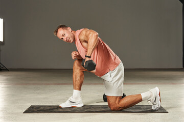 leg-supported lunge and one-arm dumbbell row by Caucasian athlete. fitness. aerobics. exercises on...