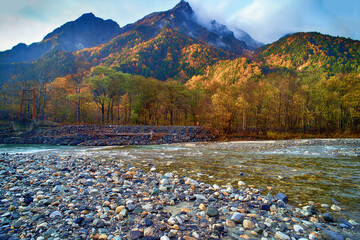 Scenery of Myojin bridge and Azusa river in late autumn at Kamikochi National Park, Matsumoto, Nagano, Japan