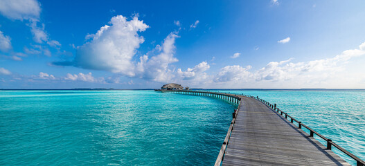 Maldives paradise island. Tropical aerial landscape, seascape long jetty pier water villas. Amazing sea sky sunny lagoon beach, tropical nature. Exotic tourism destination popular summer vacation - obrazy, fototapety, plakaty
