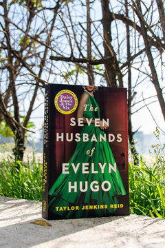 Close-up Taylor Jenkins Reid's The Seven Husbands of Evelyn Hugo novel in the garden.  