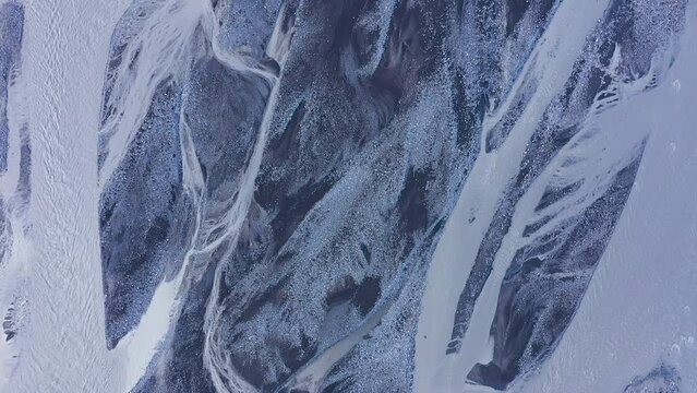   Aerial view of glacier river streams from above, Fallsjokul glacier, Iceland. Icelandic glacial river bed and moraine by drone