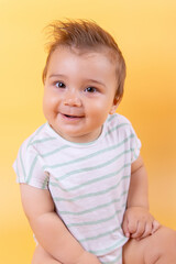 Nine months baby, on a yolk background. Emotions, beautiful child.