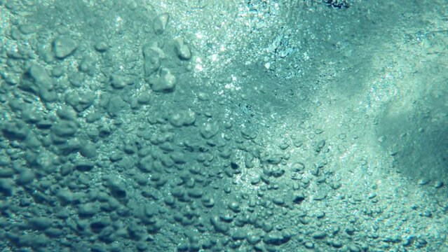 Underwater air bubbles in clean blue jacuzzi hot tub water