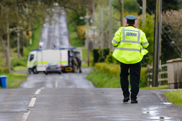 Crumlin, County Antrim - Army ATOs were called to deal with a suspicious device found on the Largy Road outside Crumlin.  The device was later declared to be a hoax. - obrazy, fototapety, plakaty