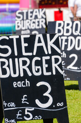 Chalk board advertising steak burgers for £3.00