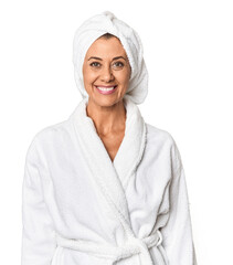 Middle-aged woman with towel post-shower in studio happy, smiling and cheerful.