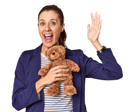 Entrepreneur with plush toy, toy industry theme receiving a pleasant surprise, excited and raising hands.