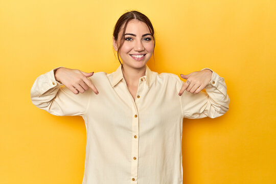 surprised pointing with finger, smiling broadly.