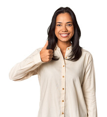 Young Filipina with long black hair in studio smiling and raising thumb up