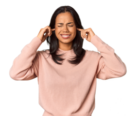 Young Filipina with long black hair in studio covering ears with fingers, stressed and desperate by a loudly ambient.