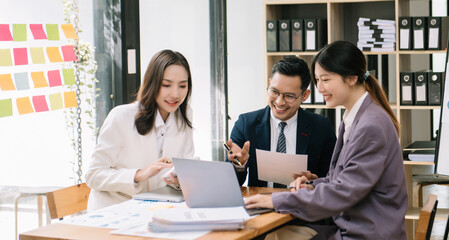 Group of Asian business meeting in planning design in creative business discussing work in the modern office