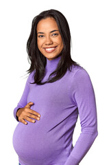 Radiant young pregnant Filipina woman in studio