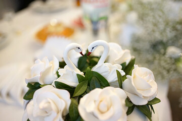 Swans made of dough decorate the wedding cake.