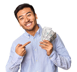 Chinese man with cash, celebrating financial victory in studio
