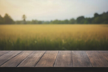a dark wooden table top with a blurred wheat field background