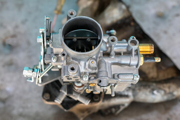 View of automobile carburetor. A carburetor (also spelled carburettor or carburetter) is a device used by a gasoline internal combustion engine to control and mix air and fuel entering the engine.