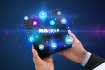 Businessman holding a foldable smartphone