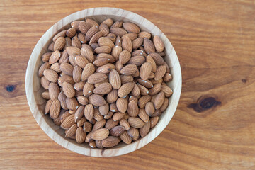 Almond kernel in a bowl. Background view from above. Healthy food