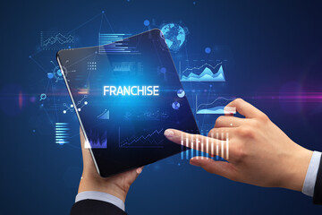 Businessman holding a foldable smartphone, business concept