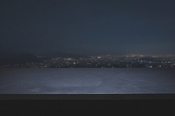a rock table top with a blurred night cityscape background