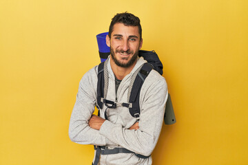 Young Hispanic man ready for hiking laughing and having fun.