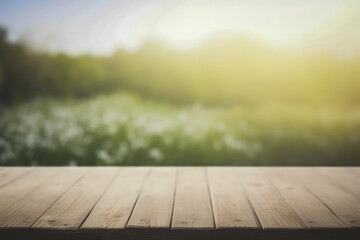 a wooden table top with a blurred green flower field background at sunrise