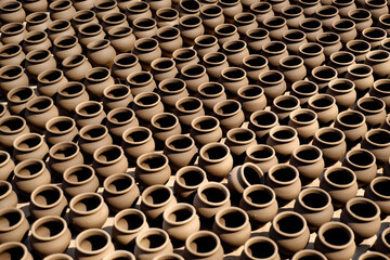 An Potter applies colour to earthenware oil pots or diyas at a workshop, ahead of the forthcoming Diwali festival, the Hindu festival of lights.