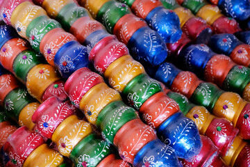An Potter applies colour to earthenware oil pots or diyas at a workshop, ahead of the forthcoming Diwali festival, the Hindu festival of lights.