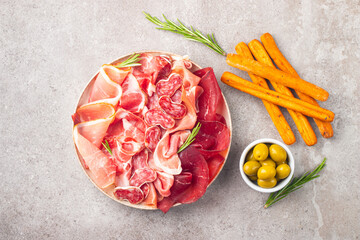 Charcuterie board. Antipasti appetizers of meat platter with salami, prosciutto crudo or jamon and olives. 