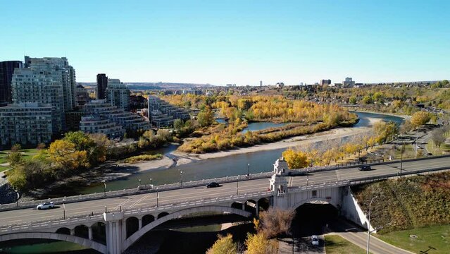 Prince's Island Park autumn foliage scenery. Aerial view of Downtown City of Calgary Centre St Bridge. Alberta, Canada. 
