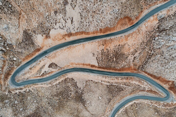 Aerial view of a road crossing the Nemrut mountains in autumn with clouds, Mount Nemrut, Turkey