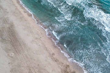Beach and waves from top view. Turquoise water background from top view. Summer seascape with dunes from air. Top view from drone. Travel concept and idea