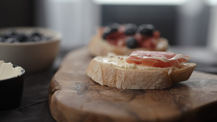 prosciutto over cream cheese on slice of ciabatta