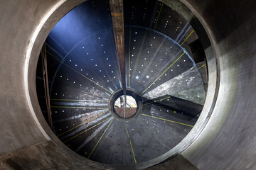 Inside view of the large sag and ball mill. A ball mill and a sag mill is a type of grinder used to grind and blend materials for use in mineral dressing processes. - obrazy, fototapety, plakaty