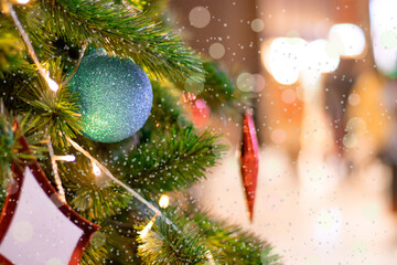 charismas tree decorations with color ball and cover in falling snow.