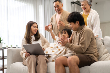 Father and mother with asian kid girl learn on laptop computer reviewing lesson study with online education e-learning.student look for educational knowledge in homeschool at home.Education