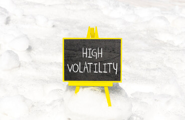 High volatility symbol. Concept words High volatility on beautiful black chalk blackboard. Chalkboard. Beautiful snow background. Business high volatility concept. Copy space.