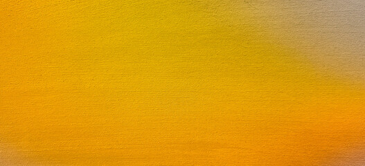 Yellow orange golden toned texture of plastered wall. Grainy background for website banner. Desktop design. A large, wide template, pattern. Color gradient. Colorful, mix, bright. Original texture