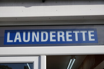 launderette sign above public clothes washing service.
