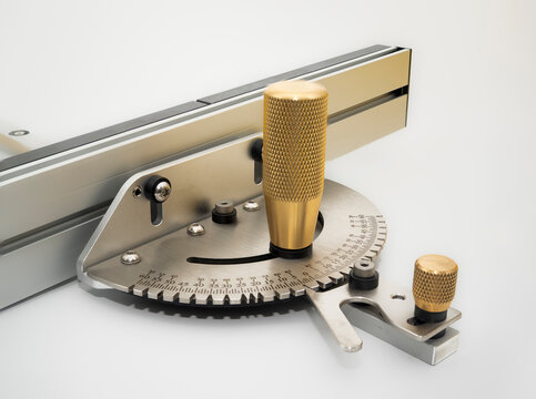 Close up of the Knurled Brass handles Steel precision  table saw mitre gauge iwith fence solated on a white background